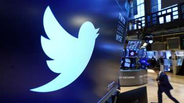 The logo for Twitter appears above a trading post on the floor of the New York Stock Exchange.