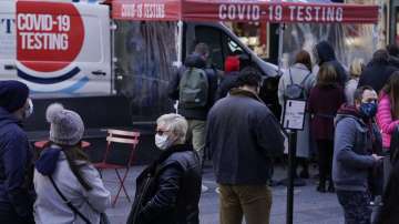 People wait in line at a COVID-19 testing site in Times Square, New York, Dec. 13, 2021. 