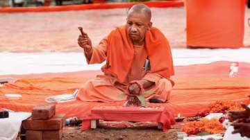 Yogi Adityanath during the foundation stone laying of the houses to be constructed under Pradhan Mantri Awas Yojana, at Lukarganj in Prayagraj, Sunday, December 26, 2021.