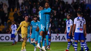 Real Madrid's Eder Militao (centre right) celebrates with teammate Casemiro after scoring a goal aga