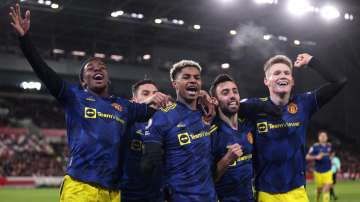 Marcus Rashford of Manchester United celebrates with teammates Anthony Elanga, Bruno Fernandes.