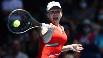 Simona Halep of Romania plays a forehand in her singles match against Danika Kovinic of Montenegro. 