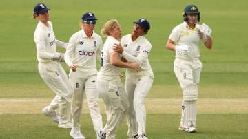 Katherine Brunt of England celebrates with her team after taking the wicket of Alyssa Healy.