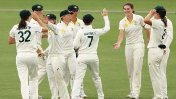 Annabel Sutherland of Australia celebrates with her team after taking the wicket of Amy Jones of ENG