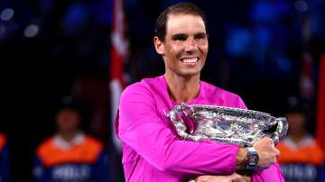 Rafael Nadal posing with Australian Open 2022 title. 