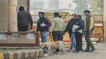 New Delhi: National Security Guard (NSG) and police personnel with a sniffer dog examine the nearby areas after an Improvised Explosive Device (IED) was found inside a bag, at Ghazipur flower market in New Delhi.