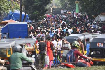 People crowd at Poisar weekly bazaar, amid rise Covid-19 cases, in Mumbai, Wednesday.