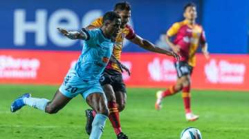 Odisha FC's Bartholomew Ogbeche (in blue) and East Bengal's Adil Kha vie for the ball during ISL mat