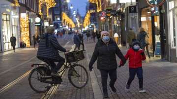 People walk in one of the capital's main shopping streets during a lockdown in Amsterdam, Netherlands, as the fast-spreading coronavirus variant omicron rages through Western Europe.