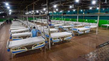 A health worker prepares a bed inside a COVID-19 isolation ward to treat patients infected with the Omicron variant, at Patliputra Sport Complex in Patna, Sunday, Jan. 2, 2022.