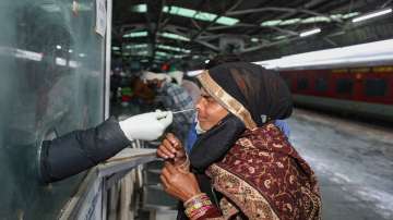 Jammu: A health worker collects swab sample of an outstation passenger for COVID-19 test, at Jammu railway station amid concern over rising Omicron cases in Jammu, Wednesday, Jan. 5, 2022.?