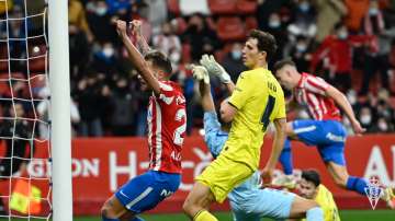 Villarreal's Pau Torres (in yellow) looks dejected after Sporting Gijon's Bogdan Milovanov scores th