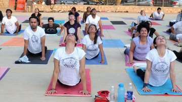 A group of people practising?Surya Namaskar.?