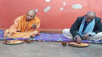 Uttar Pradesh CM Yogi Adityanath takes lunch at Dalit BJP worker's house in Gorakhpur on the occasion of Makar Sankranti.