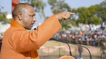 UP Chief Minister Yogi Adityanath addresses address a public meeting for the state assembly elections, in Hathras.