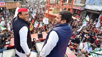 Akhilesh Yadav with Jayant Chaudhary during SP-RLD joint Samajwadi Vijay Yatra, ahead of the Uttar Pradesh Assembly elections, in Ghaziabad, Wednesday, Feb. 2, 2022.