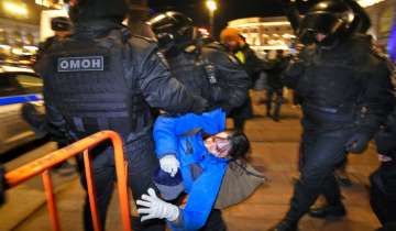 Police detain a demonstrator during an action against Russia's attack on Ukraine in St. Petersburg, Russia