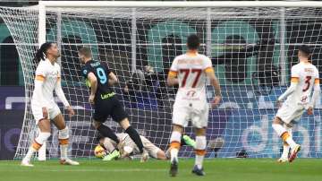 Inter Milan's Edin Dzeko (in black) scores the opening goal during the Coppa Italia match against AS