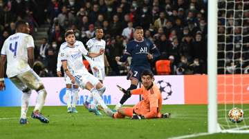 PSG's Kylian Mbappe scores the winning goal past Real Madrid's Thibaut Courtois during the first leg