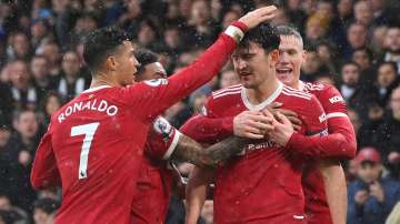 Manchester United's Harry Maguire (centre) celebrates with teammates Scott McTominay, Jesse Lingard 