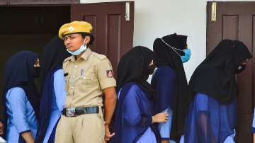 Students walk to the Principals Chamber for a meeting after they were not allowed to enter the PU College while wearing Hijab, in Udupi,
