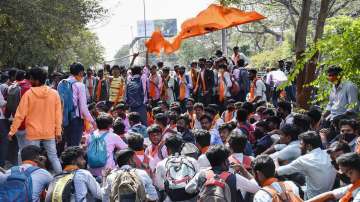 Shimoga: Students wearing saffron shawl block a road during protest over Hijab controversy, in Shimoga, Tuesday, Feb. 8, 2022.