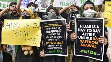 Delhi University Muslim Students Federation activists hold placards during a protest over the hijab controversy in Karnataka, outside Arts Faculty in New Delhi, Tuesday, Feb. 8, 2022.?