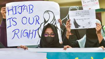 Muslim women hold placards while wearing burqa and hijab to stage a demonstration in support of female Muslim students, in Bengaluru, Monday, Feb. 7, 2022.