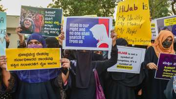 Muslim women hold placards while wearing burqa and hijab to stage a demonstration in support of female Muslim students, in Bengaluru, Monday, Feb. 7, 2022.
