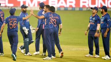 Indian bowler Harshal Patel celebrates with teammates after the wicket of West Indian batsman Nichol