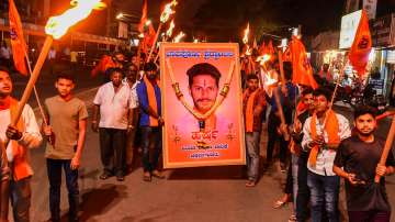 Members of various pro-hindu organisations stage a protest march over the alleged murder of Bajrang Dal activist Harsha in Shivamogga, in Chikmagalur, Monday, Feb. 21, 2022.