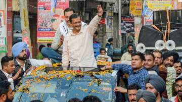Delhi CM and AAP convener Arvind Kejriwal waves at the people, during a roadshow for the upcoming Punjab Assembly elections, in Jalandhar, Wednesday, Feb 16, 2022.