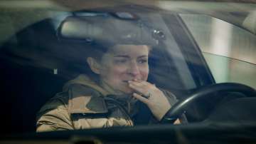 A woman weeps in her car after crossing the border from Ukraine at the Romanian-Ukrainian border, in Sighetu Marmatiei, Romania.