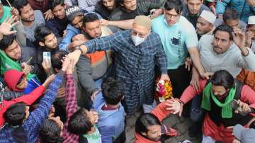 AIMIM president Asaduddin Owaisi greets the supporters during a door-to-door campaign ahead of the upcoming UP Assembly elections, in Meerut, Thursday, Feb. 03, 2022.
