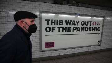 A man wearing a face mask to curb the spread of coronavirus walks past.