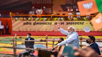 Prime Minister Narendra Modi waves towards supporters during Booth Vijay Sammelan for the ongoing Uttar Pradesh Assembly elections, in Varanasi.