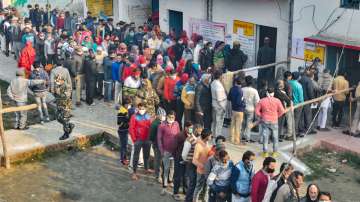 Citizens wait to cast their vote at a polling booth, during the second phase of Uttar Pradesh Assembly elections, in Moradabad, Monday, Feb. 14, 2022.