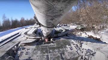 In this photo taken from video provided by the Russian Defense Ministry Press Service on Wednesday, Feb. 16, 2022, Russian army tanks are loaded onto railway platforms to move back to their permanent base after drills in Russia.