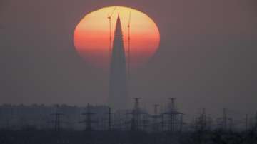 The Lakhta Centre tower under construction, the headquarters of Russian gas monopoly Gazprom, is silhouetted against the sunset in St. Petersburg, Russia, on April 15, 2018. Russia has been fulfilling its long-term contracts to supply gas to Europe, but it's been selling less on the spot market and hasn't been filling the storage containers it owns in Europe, experts say. 