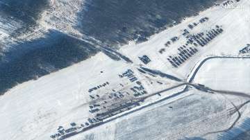 This Feb. 4, 2022, satellite image provided by Maxar Technologies shows the troops and equipment in Rechitsa, Belarus, north of the border with Ukraine.