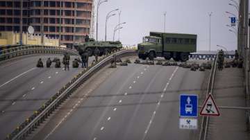 Ukrainian soldiers take position on a bridge inside the city of Kyiv, Ukraine as Russia pressed its invasion to the outskirts of the capital.