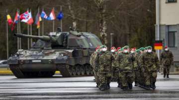 German Bundeswehr soldiers of the NATO enhanced forward presence battalion waits to greet German Defense Minister Christine Lambrecht upon his arrival at the Rukla military base some 100 kms (62.12 miles) west of the capital Vilnius, Lithuania. Germany is sending additional troops to Lithuania in response to Russia's military build-up on the border with Ukraine and the worsening security situation in the Baltic states.