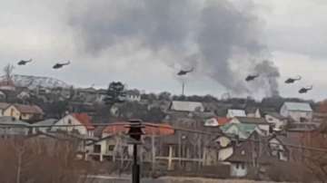 In this handout photo taken from video released by Ukrainian Police Department Press Service, Military helicopters apparently Russian, fly over the outskirts of Kyiv, Ukraine, Thursday, Feb. 24, 2022.?