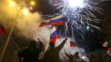 People wave Russian national flags celebrating the recognizing the independence in the center of Donetsk, the territory controlled by pro-Russian militants, eastern Ukraine, late Monday, Feb. 21, 2022. 