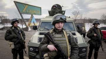 Ukrainian National guard soldiers guard a mobile checkpoint together with the Ukrainian Security Service agents and police officers during a joint operation in Kharkiv, Ukraine, Thursday, Feb. 17, 2022. 
 