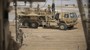 In this photo released by the U.S. Air Force, U.S. Army troops work near a Patriot missile battery at Al-Dhafra Air Base in Abu Dhabi, United Arab Emirates, May 5, 2021. 