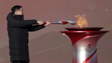 Chinese Vice Premier Han Zheng lights the torch before the start of the torch relay for the 2022 Winter Olympics at the Olympic Forest Park in Beijing on Wednesday.