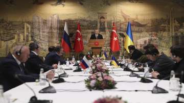 In this photo provided by Turkish Presidency, Turkish President Recep Tayyip Erdogan, center, gives a speech to welcome the Russian, left, and Ukrainian delegations ahead of their talks, in Istanbul, Turkey, Tuesday, March 29, 2022. 