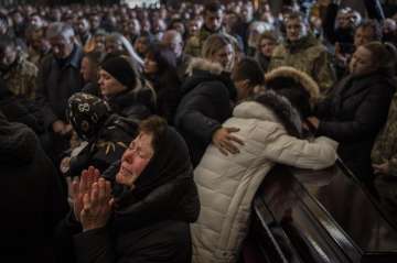 Relatives and friends attend a funeral ceremony for four of the Ukrainian military servicemen, who were killed during an airstrike in a military base in Yarokiv, in a church in Lviv, Ukraine