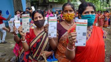 Beneficiaries show their Aadhaar Card as they wait to receive a dose of COVID-19 vaccine in Nadia district, Friday, Sept. 10, 2021.